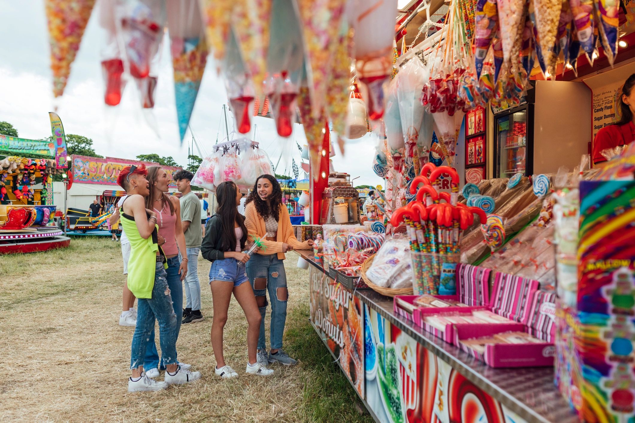 Festival guests ordering food from a fairground stand